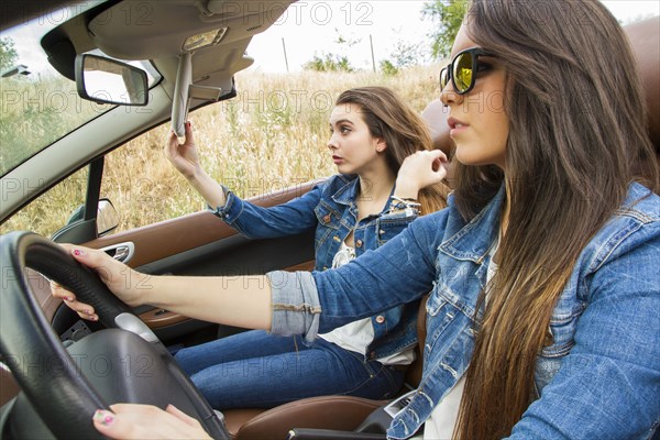 Women driving in convertible