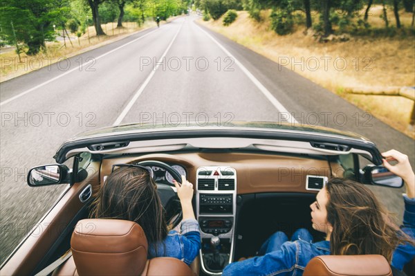 Women driving in convertible