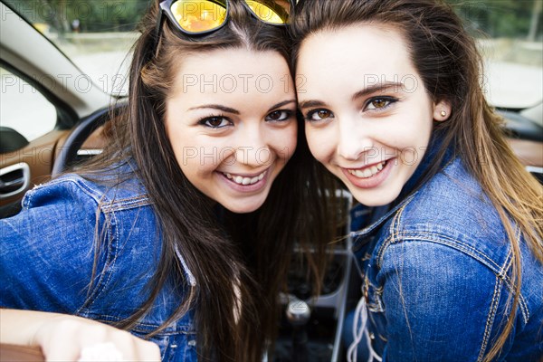 Women smiling in convertible