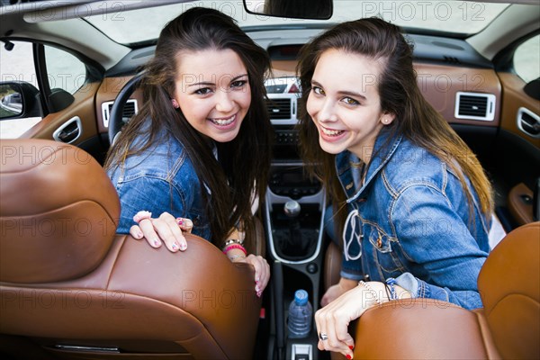 Women smiling in convertible