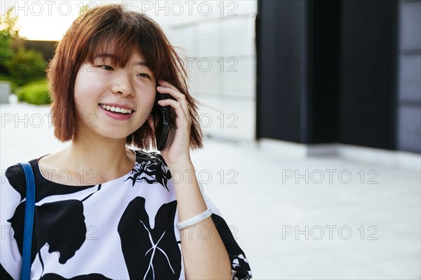 Chinese woman talking on cell phone