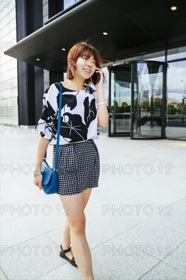 Chinese woman talking on cell phone