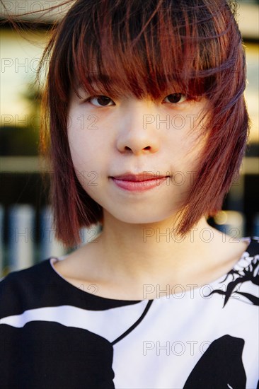 Close up of smiling Chinese woman in wind