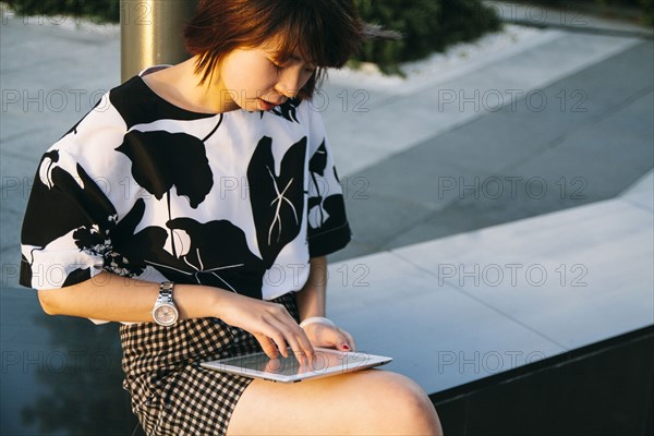 Chinese woman using digital tablet