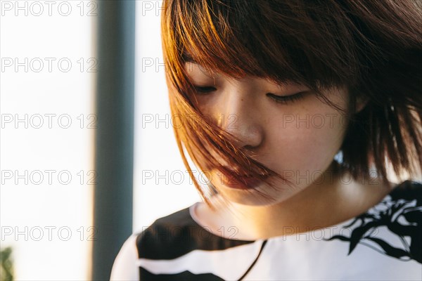 Hair of Chinese woman blowing in wind