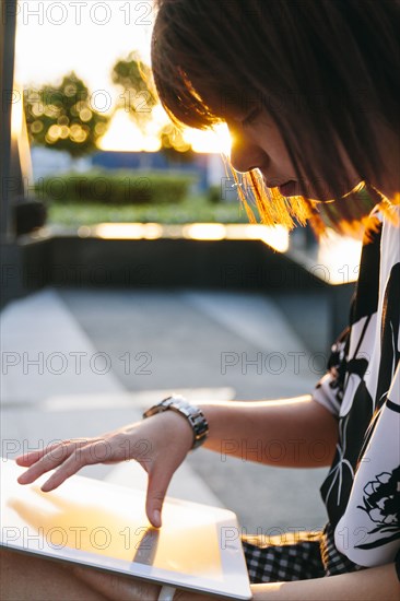 Chinese woman using digital tablet