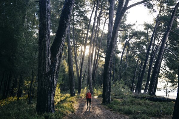 Caucasian woman standing on path in forest