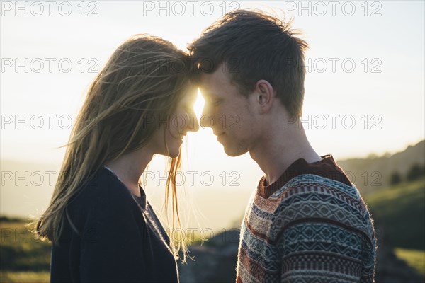 Caucasian couple face to face in landscape