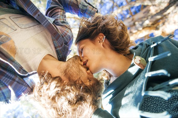 View from below of Caucasian couple kissing