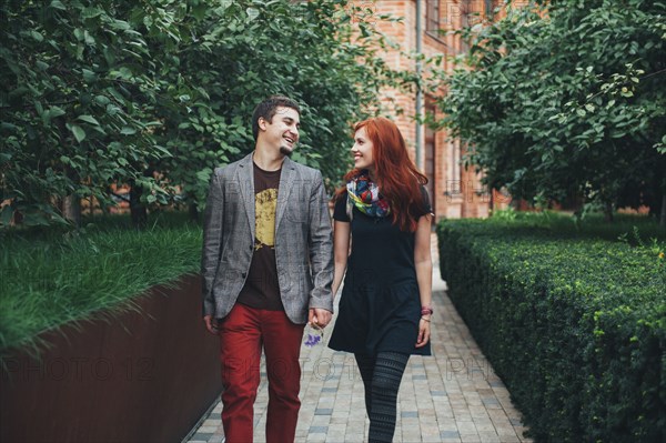 Smiling Caucasian couple walking in city