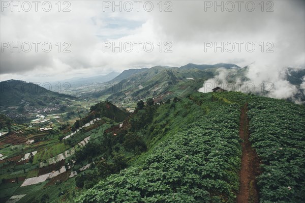 Clouds over mountain and green valley