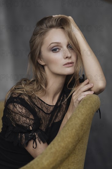 Portrait of glamorous Caucasian woman sitting on sofa