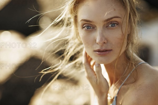 Wind blowing hair of Caucasian woman