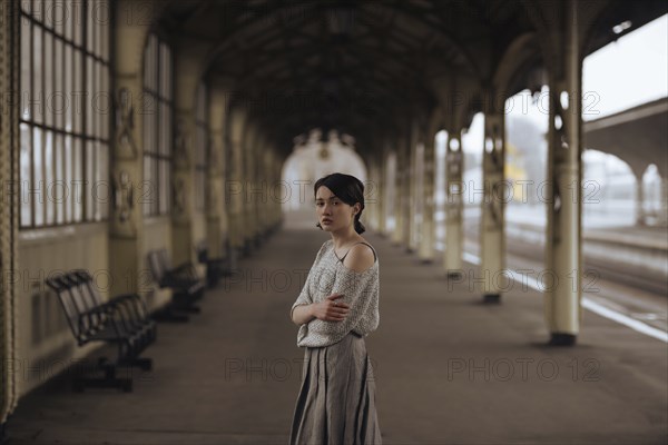 Portrait of serious Caucasian woman at train station