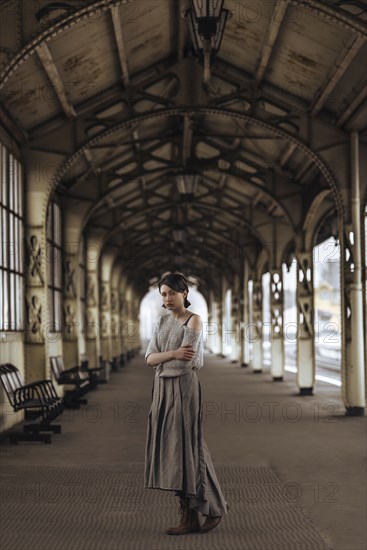 Portrait of serious Caucasian woman at train station