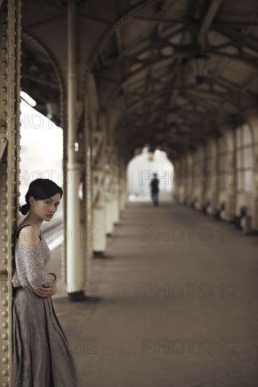 Portrait of serious Caucasian woman at train station