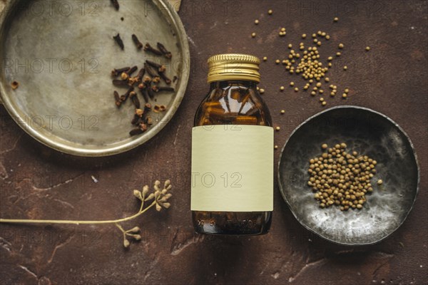 Alternative medicine jar with blank label near seeds