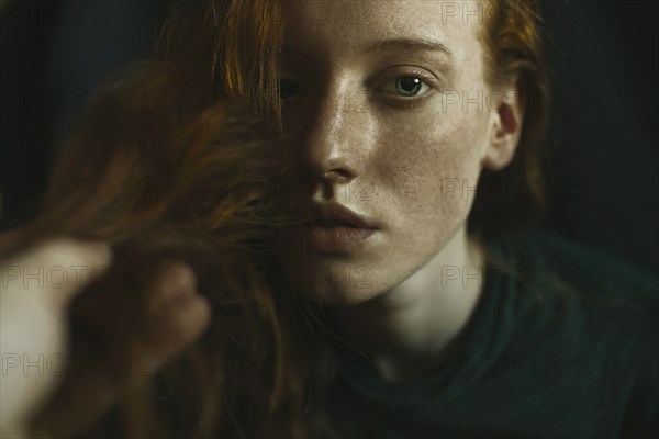 Caucasian woman holding hair