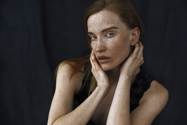 Close up of serious Caucasian woman with freckles