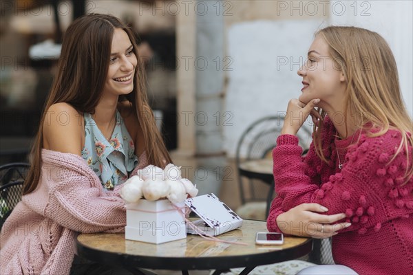 Caucasian women sitting at table