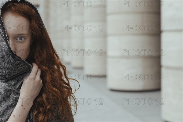 Caucasian woman hiding face behind hood