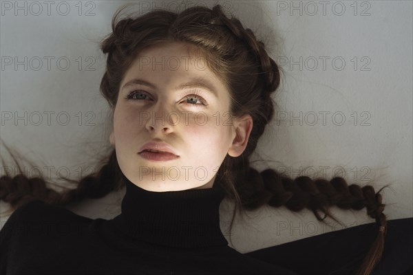 Portrait of serious Caucasian woman looking up