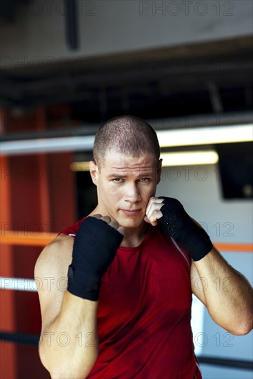 Portrait of Caucasian boxer with fists raised