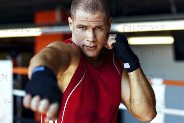 Portrait of Caucasian boxer punching