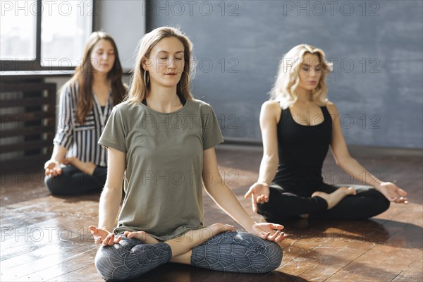 Caucasian women meditating in yoga class