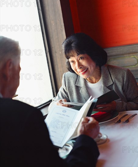 Senior couple ordering from menu