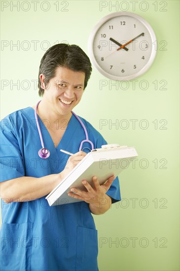 Portrait of male nurse with clipboard