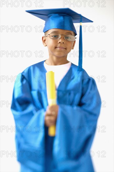 Little boy wearing cap and gown