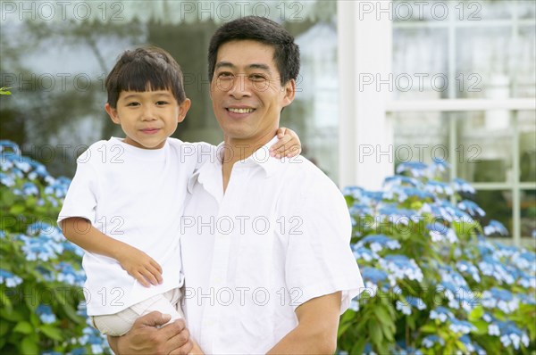 Portrait of father holding son