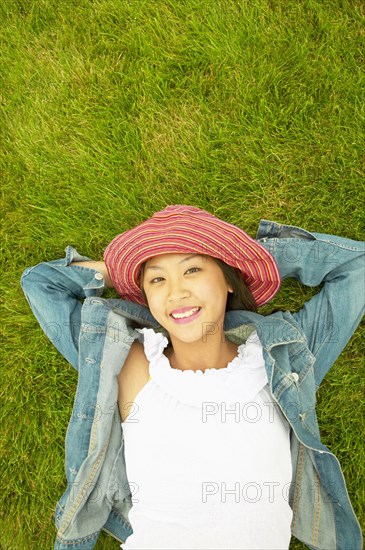 Portrait of woman laying in grass