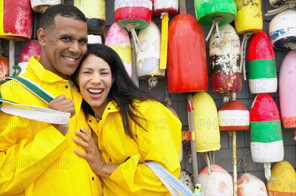 Portrait of couple standing in front of buoys