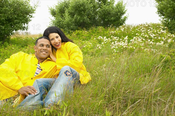 Portrait of couple laying in field