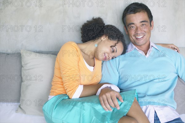 Portrait of couple sitting on couch