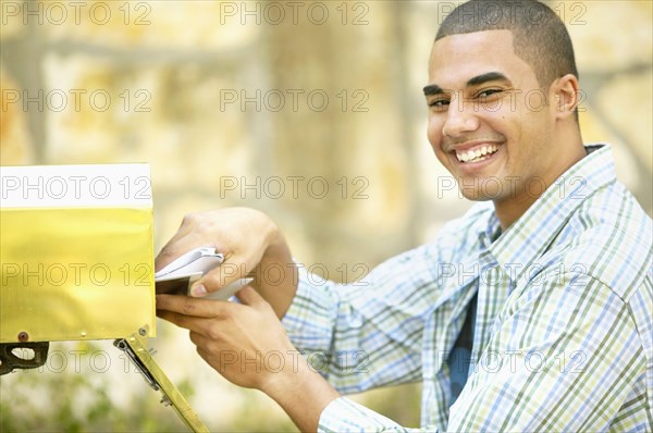 Man getting mail from mailbox