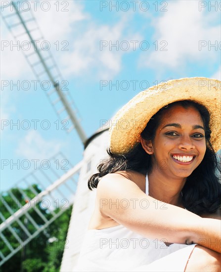 Young woman smiling with sun hat