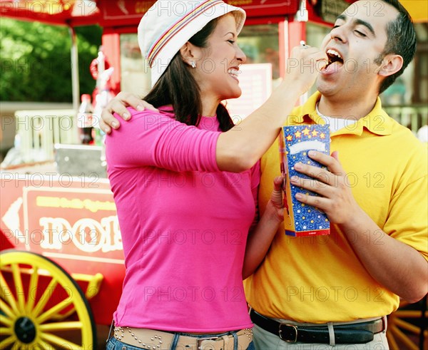 Young couple eating popcorn