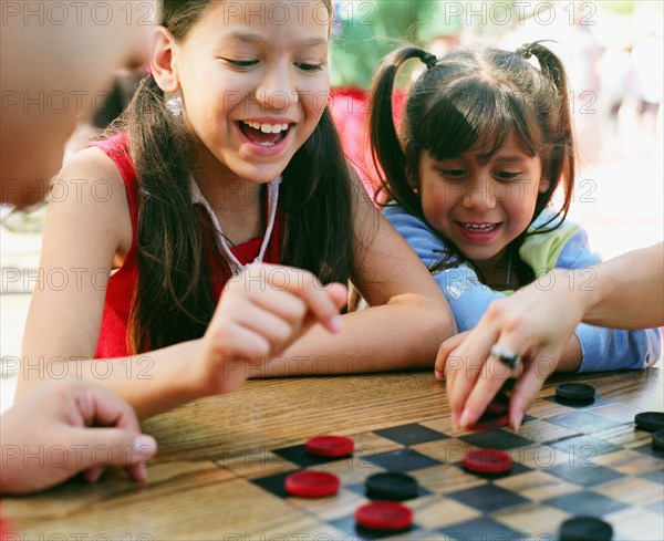 Sisters playing checkers