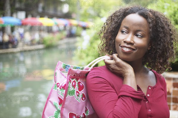 Mid adult woman carrying a shopping bag