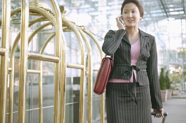 Businesswoman on mobile phone in hotel lobby