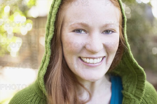 Close up of a young woman in green hood