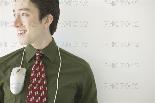 Businessman with computer mouse around neck