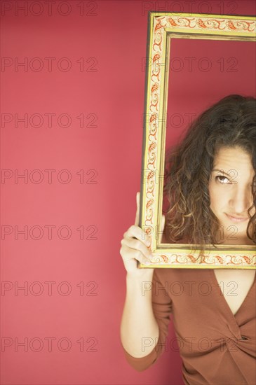 Young woman holding a picture frame