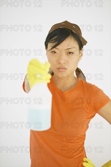 Young woman holding a spray bottle