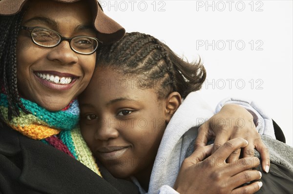 Mother hugging daughter