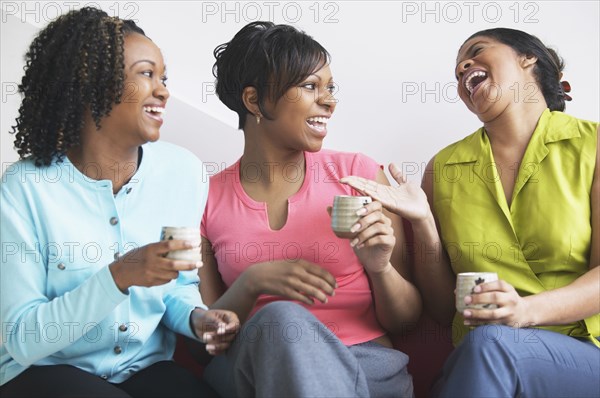 Three women together laughing