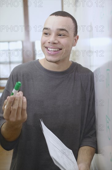 Teenage boy standing near whiteboard